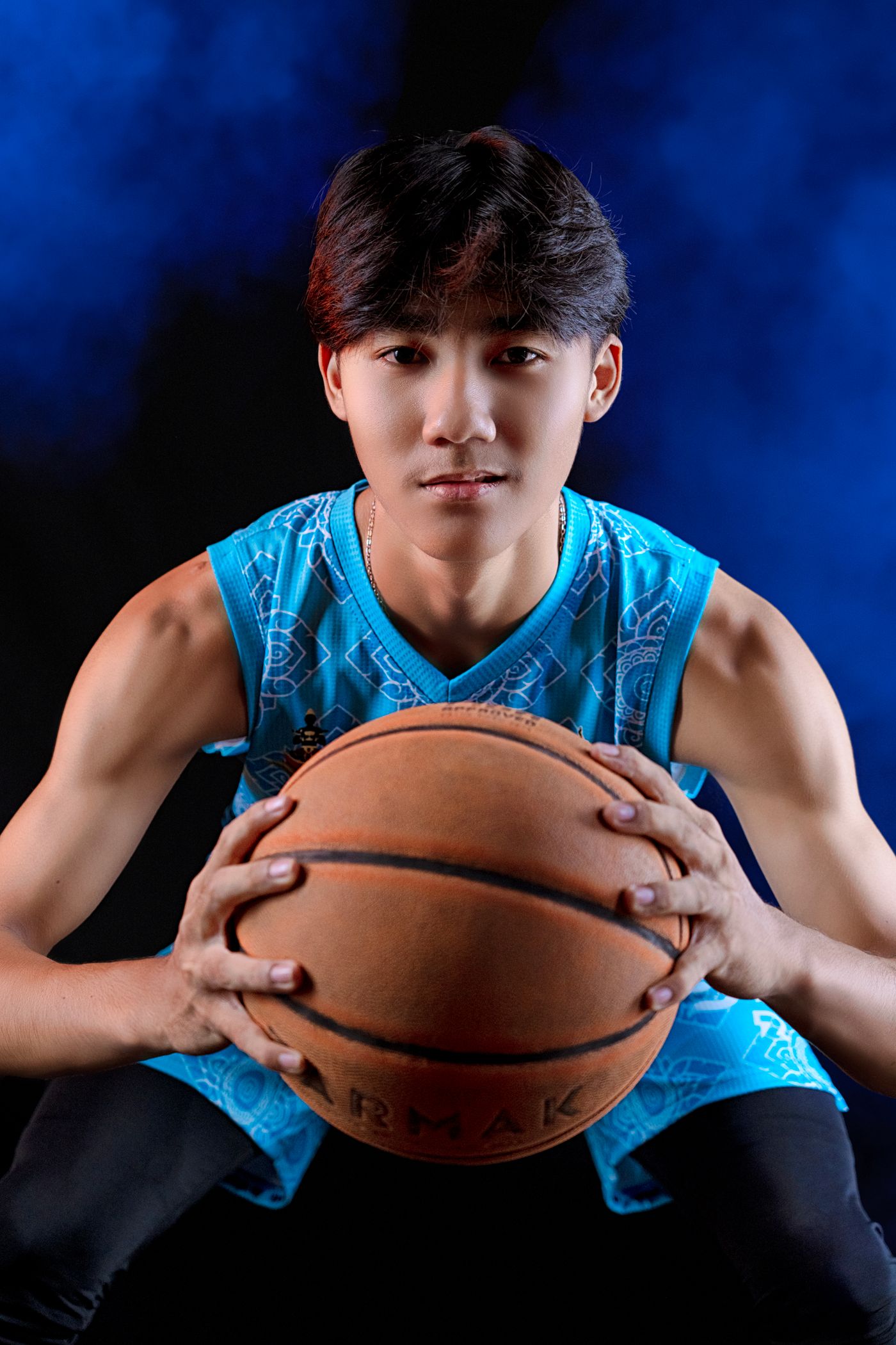 A high school basketball player in a team jersey