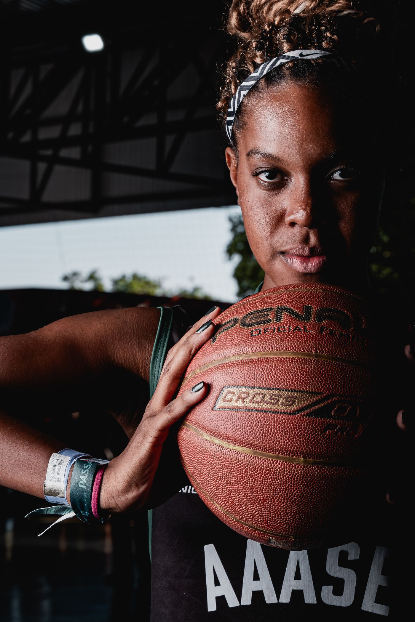 A high school basketball player holding a ball