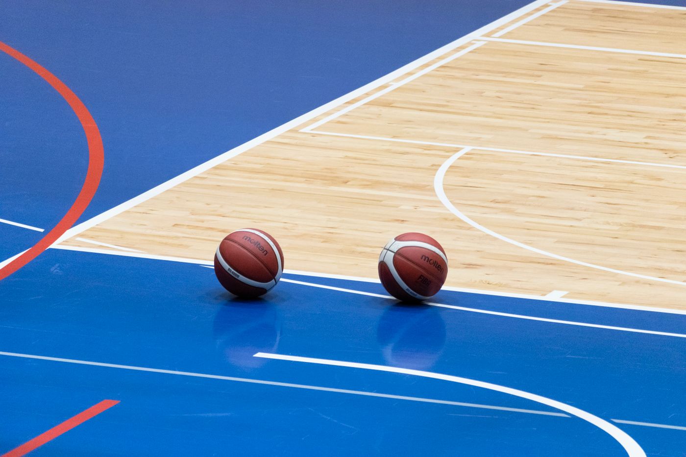 A basketball court with two balls on the line